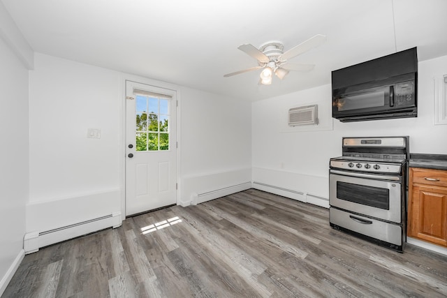 15 W Granada Ave, Lindenhurst, NY 11757 - kitchen featuring stainless steel gas range, a baseboard radiator, wood finished floors, black microwave, and dark countertops
