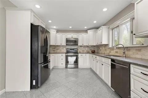 237 Hynes Rd, Poughquag, NY 12570 - kitchen with stainless steel appliances, a sink, backsplash, white cabinets, and recessed lighting