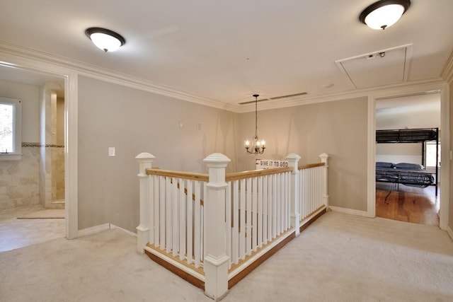 237 Hynes Rd, Poughquag, NY 12570 - hallway featuring attic access, an upstairs landing, carpet flooring, and ornamental molding