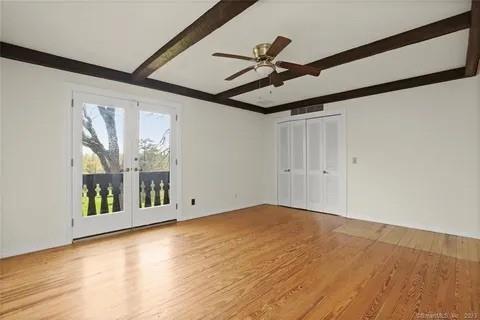 237 Hynes Rd, Poughquag, NY 12570 - empty room featuring beamed ceiling, wood finished floors, a ceiling fan, and french doors