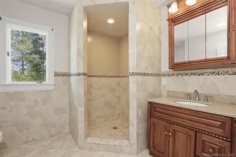 237 Hynes Rd, Poughquag, NY 12570 - full bathroom with a tile shower, tile walls, and vanity
