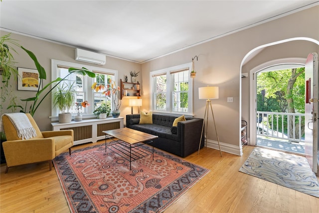 27 Luzern Rd, Dobbs Ferry, NY 10522 - living area featuring a wall mounted AC, light wood-type flooring, crown molding, radiator, and baseboards