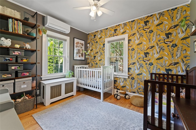 27 Luzern Rd, Dobbs Ferry, NY 10522 - bedroom featuring a wall mounted AC, wallpapered walls, ornamental molding, wood finished floors, and baseboards