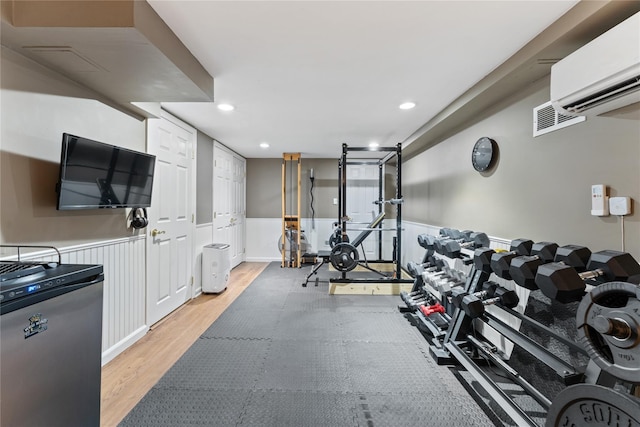 27 Luzern Rd, Dobbs Ferry, NY 10522 - exercise area with light wood finished floors, a wall mounted air conditioner, wainscoting, and recessed lighting