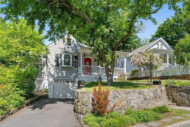 27 Luzern Rd, Dobbs Ferry, NY 10522 - view of front of home with covered porch, a garage, and driveway