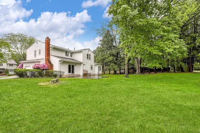 1 Lodi Ln, Monsey, NY 10952 - view of grassy yard with a patio area and a garage