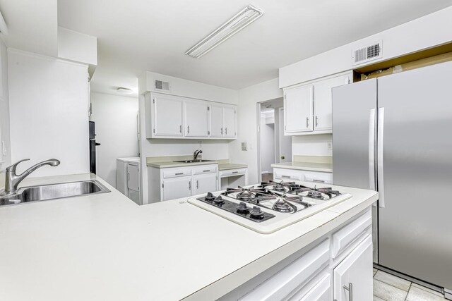 1 Lodi Ln, Monsey, NY 10952 - kitchen with freestanding refrigerator, a sink, independent washer and dryer, and white gas cooktop
