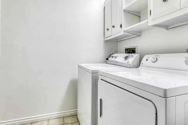 1 Lodi Ln, Monsey, NY 10952 - washroom featuring separate washer and dryer, cabinet space, light tile patterned floors, and baseboards