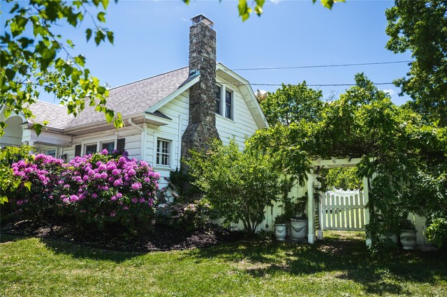 222 Lakeside Rd, Newburgh, NY 12550 - view of side of home featuring roof with shingles and a chimney
