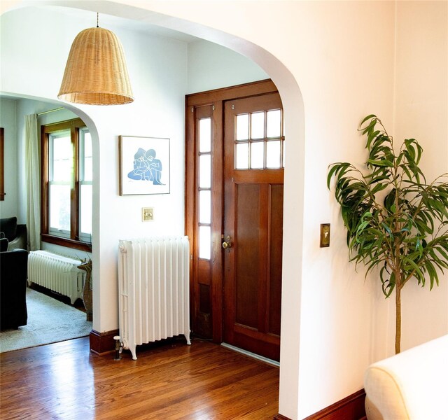 222 Lakeside Rd, Newburgh, NY 12550 - entrance foyer with radiator, wood finished floors, and arched walkways