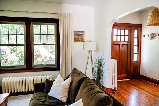 222 Lakeside Rd, Newburgh, NY 12550 - foyer with radiator heating unit, arched walkways, wood finished floors, and baseboards