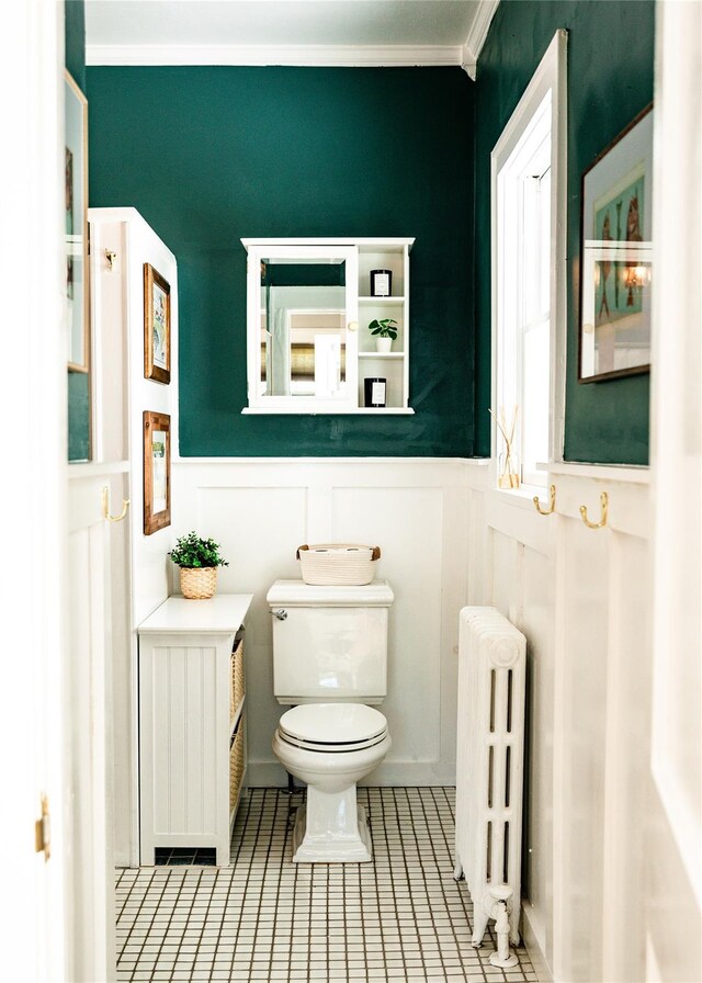 222 Lakeside Rd, Newburgh, NY 12550 - half bathroom with radiator heating unit, toilet, wainscoting, tile patterned flooring, and ornamental molding