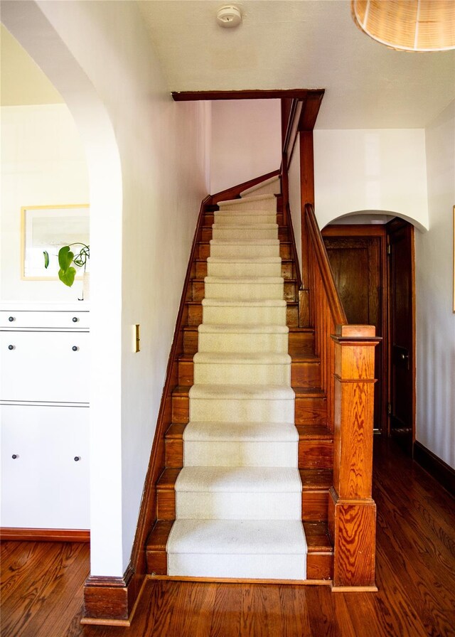 222 Lakeside Rd, Newburgh, NY 12550 - stairway with arched walkways, wood finished floors, and baseboards