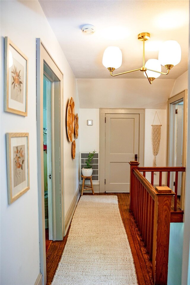 222 Lakeside Rd, Newburgh, NY 12550 - corridor with dark wood-style flooring, a chandelier, and an upstairs landing