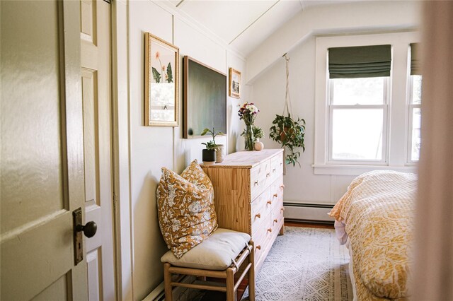 222 Lakeside Rd, Newburgh, NY 12550 - bedroom with a baseboard heating unit, vaulted ceiling, and light wood finished floors