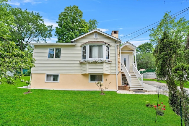 7 Crestwood Trl, Monroe, NY 10950 - back of house featuring a lawn, a chimney, and stucco siding