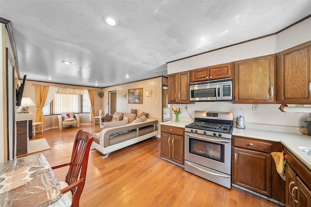 7 Crestwood Trl, Monroe, NY 10950 - kitchen with appliances with stainless steel finishes, light countertops, open floor plan, light wood-style flooring, and recessed lighting
