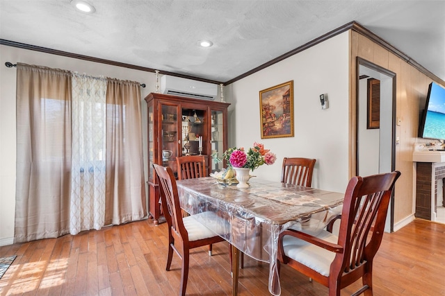7 Crestwood Trl, Monroe, NY 10950 - dining area featuring an AC wall unit, crown molding, light wood-style flooring, recessed lighting, and a textured ceiling