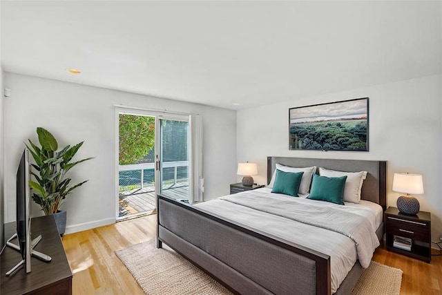 15 Elizabeth Ln, Quogue, NY 11959 - bedroom featuring access to exterior, wood finished floors, and baseboards