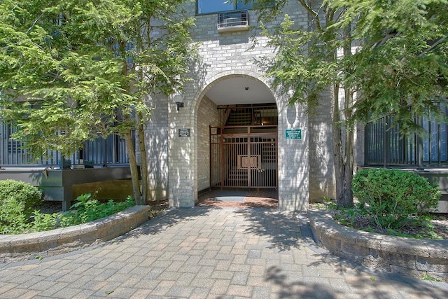 107 N Broadway Unit 201, White Plains, NY 10603 - view of exterior entry featuring brick siding and a gate