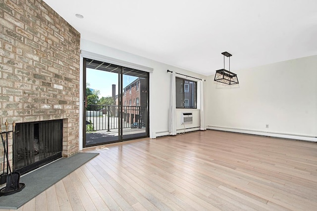 107 N Broadway Unit 201, White Plains, NY 10603 - unfurnished living room with wood finished floors, a baseboard heating unit, and a fireplace