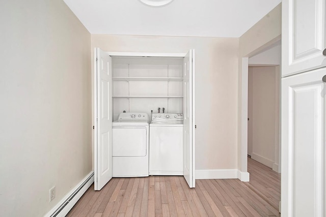 107 N Broadway Unit 201, White Plains, NY 10603 - laundry area with washer and dryer, a baseboard heating unit, light wood finished floors, and baseboards
