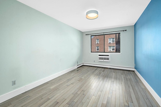 107 N Broadway Unit 201, White Plains, NY 10603 - spare room featuring a baseboard heating unit, an AC wall unit, wood finished floors, and baseboards