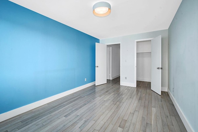 107 N Broadway Unit 201, White Plains, NY 10603 - unfurnished bedroom featuring wood finished floors, a closet, and baseboards