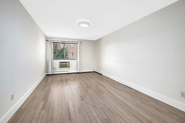 107 N Broadway Unit 201, White Plains, NY 10603 - empty room with wood-type flooring, baseboards, and a wall mounted air conditioner