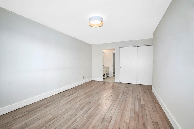 107 N Broadway Unit 201, White Plains, NY 10603 - unfurnished bedroom with light wood-type flooring, a closet, and baseboards