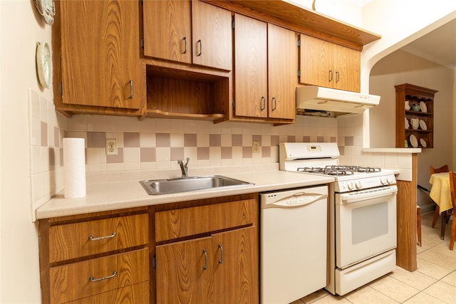 28-06 34th Ave, Astoria, NY 11106 - kitchen with white appliances, under cabinet range hood, a sink, backsplash, and light countertops