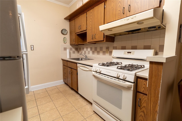 28-06 34th Ave, Astoria, NY 11106 - kitchen featuring white appliances, under cabinet range hood, a sink, crown molding, and tasteful backsplash