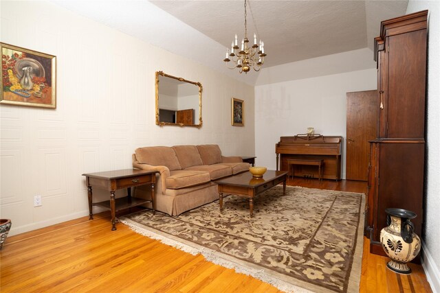 28-06 34th Ave, Astoria, NY 11106 - living area featuring light wood-type flooring, a chandelier, and baseboards