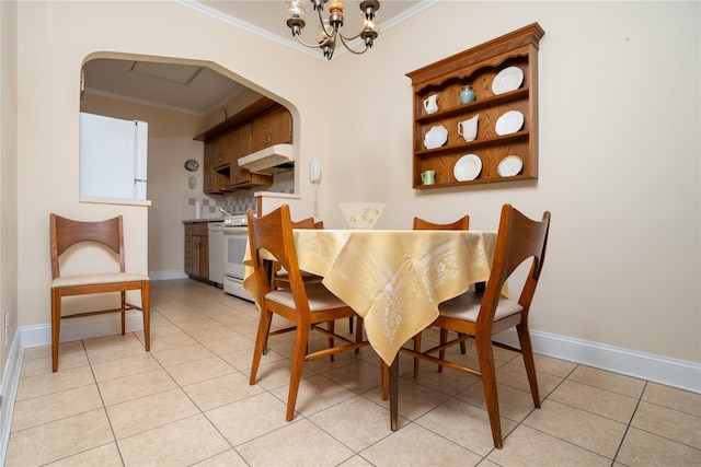 28-06 34th Ave, Astoria, NY 11106 - dining space with ornamental molding, arched walkways, light tile patterned floors, a chandelier, and baseboards