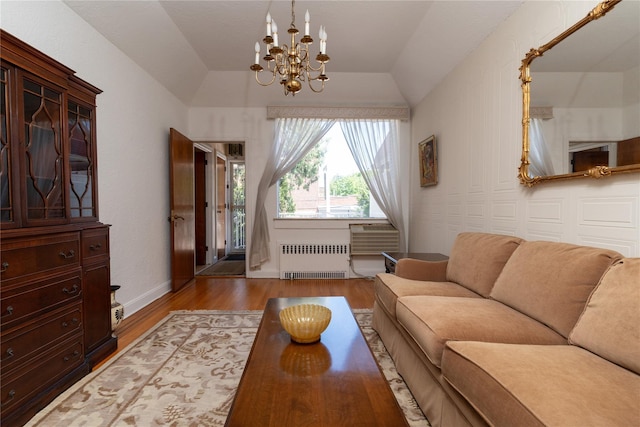 28-06 34th Ave, Astoria, NY 11106 - living area with radiator heating unit, lofted ceiling, wood finished floors, and a chandelier