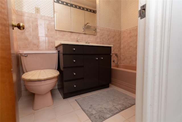 28-06 34th Ave, Astoria, NY 11106 - full bathroom with toilet, tile patterned floors, tile walls, a bath, and vanity