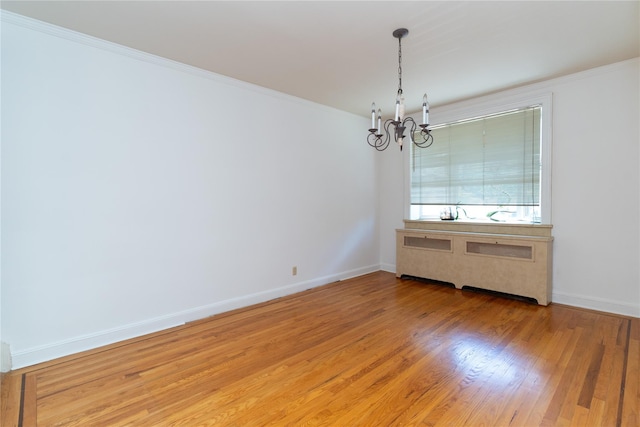 28-06 34th Ave, Astoria, NY 11106 - unfurnished room with a chandelier, light wood-type flooring, baseboards, and ornamental molding
