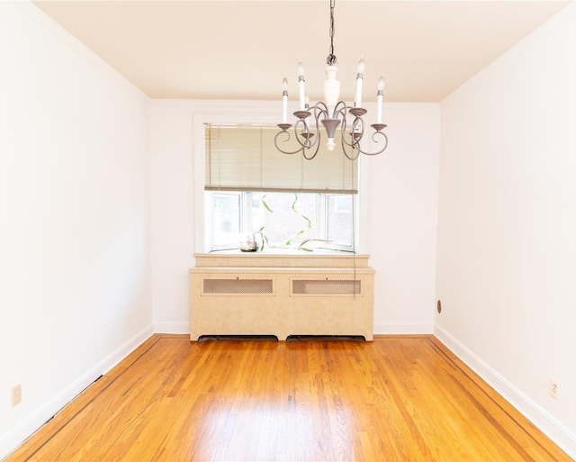 28-06 34th Ave, Astoria, NY 11106 - unfurnished dining area featuring a chandelier, light wood-style flooring, baseboards, and ornamental molding