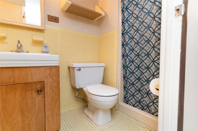 28-06 34th Ave, Astoria, NY 11106 - bathroom featuring toilet, a stall shower, vanity, tile walls, and tile patterned flooring