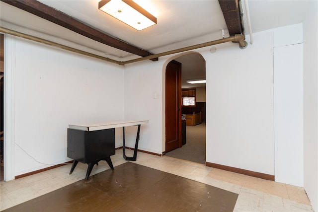 28-06 34th Ave, Astoria, NY 11106 - below grade area featuring arched walkways, light flooring, and baseboards