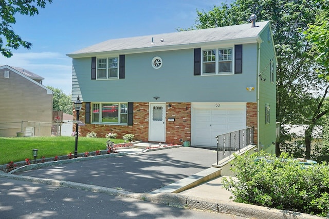 53 Prior Pl, Yonkers, NY 10710 - view of front facade featuring a garage, driveway, brick siding, and a front yard