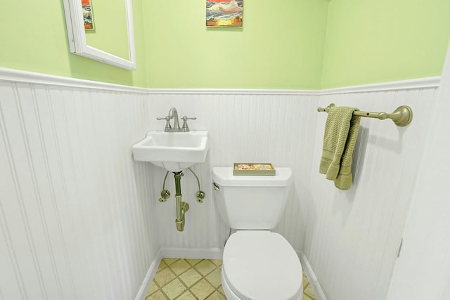 53 Prior Pl, Yonkers, NY 10710 - half bathroom with toilet and a wainscoted wall
