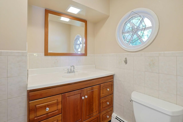 53 Prior Pl, Yonkers, NY 10710 - bathroom with tile walls, vanity, toilet, wainscoting, and a baseboard radiator