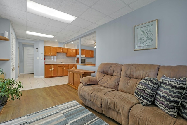 53 Prior Pl, Yonkers, NY 10710 - living area featuring light wood-type flooring, baseboards, and a drop ceiling