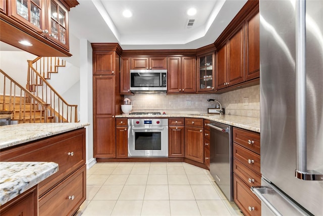 1229 Estates Ln Triplex, Unit Triplex, Bayside, NY 11360 - kitchen featuring appliances with stainless steel finishes, a sink, tasteful backsplash, light stone counters, and glass insert cabinets