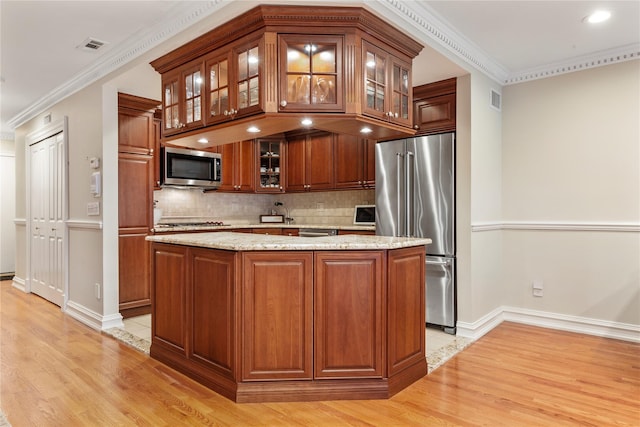 1229 Estates Ln Triplex, Unit Triplex, Bayside, NY 11360 - kitchen featuring appliances with stainless steel finishes, light wood-type flooring, decorative backsplash, a kitchen island, and crown molding