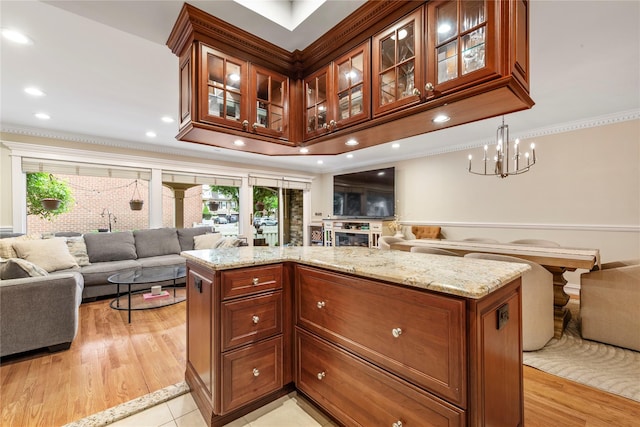 1229 Estates Ln Triplex, Unit Triplex, Bayside, NY 11360 - kitchen with open floor plan, ornamental molding, light stone countertops, a fireplace, and glass insert cabinets