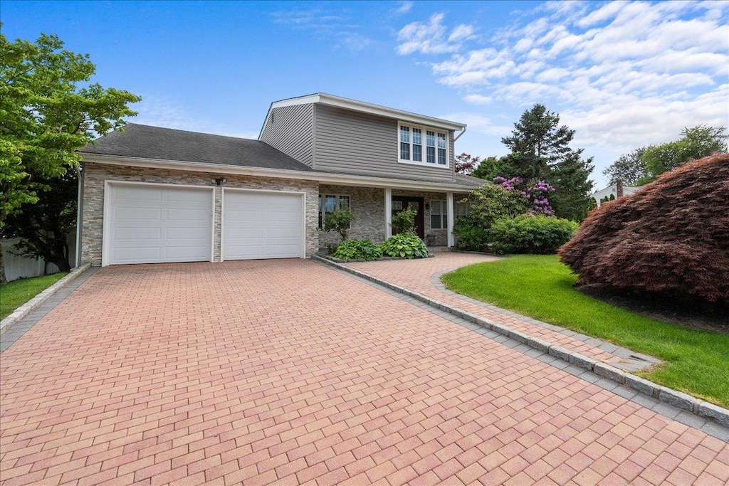 18 Stirrup Ln, Glen Cove, NY 11542 - traditional-style home with a garage, decorative driveway, and a front yard