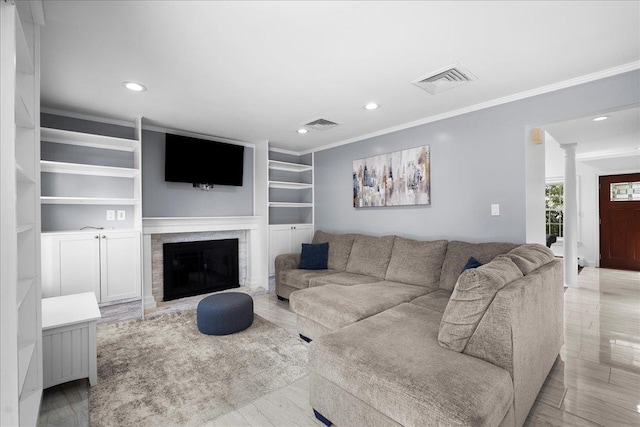 18 Stirrup Ln, Glen Cove, NY 11542 - living area featuring ornamental molding, decorative columns, recessed lighting, a glass covered fireplace, and built in features