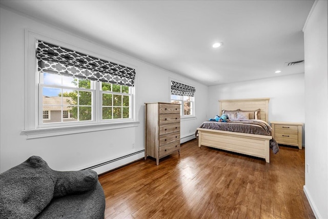 18 Stirrup Ln, Glen Cove, NY 11542 - bedroom with wood finished floors, a baseboard radiator, recessed lighting, and baseboards